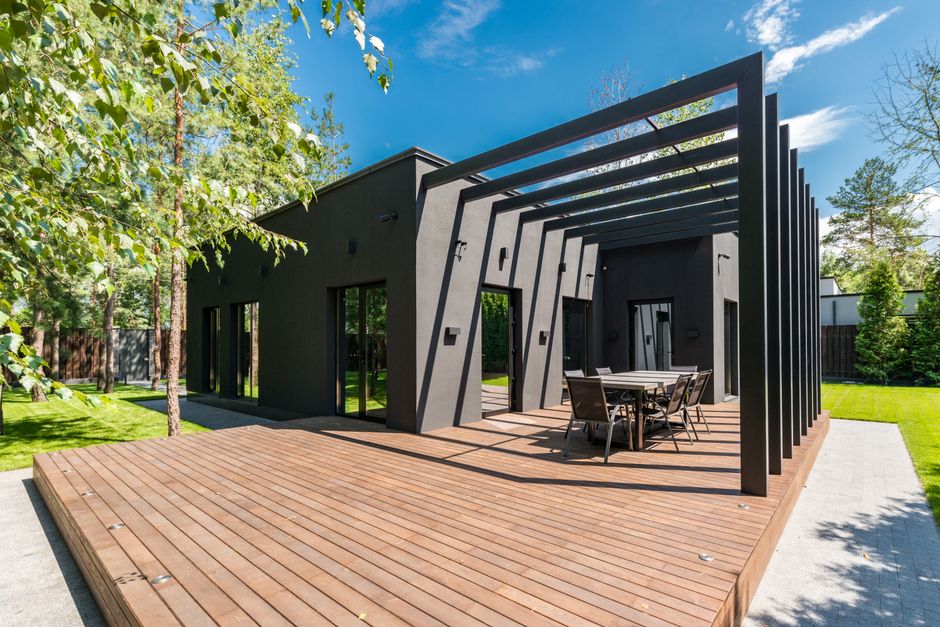 Finished wooden deck and patio space in a backyard